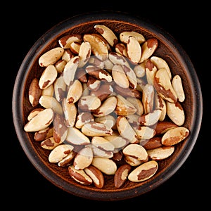 Brazil nut in a plate black background