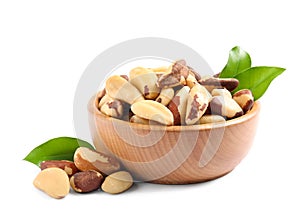 Brazil nuts in wooden bowl on white photo