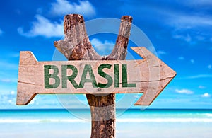 Brazil (in Portuguese) wooden sign with a beach on background