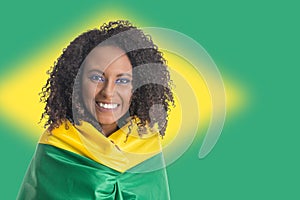 Brazilian woman fan celebrating on football match on white background. Brazil colors. photo