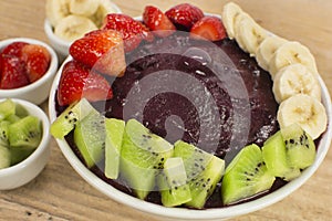 Brazilian acai and fruits in wood background close