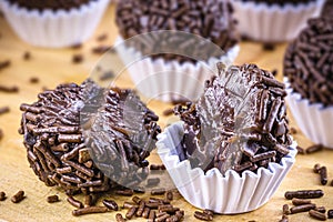 Brazilian Brigadeiro candy or negrinho, a Brazilian chocolate candy, with a bite mark photo