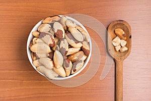 Brazilian Castanha do Para into a bowl and spoon photo