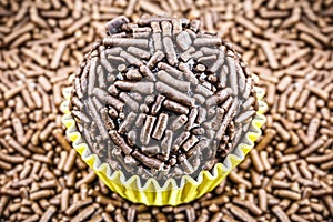 Brazilian chocolate candy called brigadeiro, with granulated chocolate in the background photo