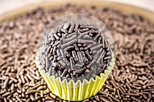 Brazilian chocolate candy called brigadeiro, with granulated chocolate in the background photo