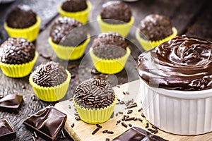 Brazilian chocolate truffle bonbon brigadeiro on wooden table. Sweet typical of children`s parties photo