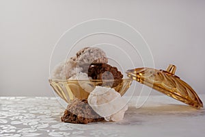 Brazilian cocada coconut candy placed in a glass jar on a table with white towel, selective focus