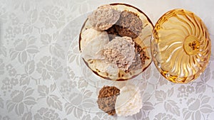 Brazilian cocada coconut candy placed in a glass jar on a table with white towel, selective focus