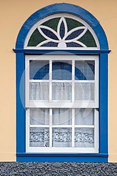Brazilian colonial house window facade in a yellow wall