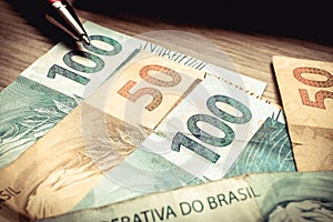 Real - Brazilian currency. Money on the wooden table. photo