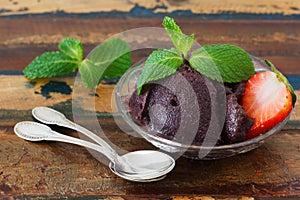 Brazilian dessert Acai pulp in glass with strawberry and mint