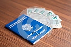 Brazilian document work and social security ( Carteira de Trabalho e Previdencia Social) with brazilian money
