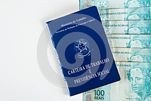 Brazilian document work and social security Carteira de Trabalho e Previdencia Social with Brazilian money banknotes