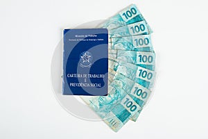 Brazilian document work and social security Carteira de Trabalho e Previdencia Social with Brazilian money banknotes