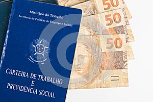 Brazilian document work and social security Carteira de Trabalho e Previdencia Social with Brazilian money banknotes