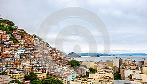 Brazilian favelas on the hill with city downtown below at the tropical bay, Rio De Janeiro, Brazil
