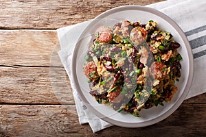 Brazilian Feijao Tropeiro traditional dish, made with beans, bacon, sausage, collard greens, eggs and manioc flour. horizontal to photo