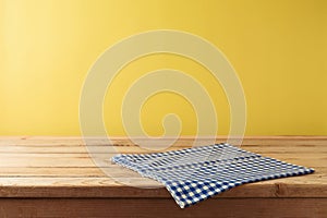 Brazilian Festa Junina summer harvest festival concept. Empty wooden table with tablecloth over yellow background. Mock up for