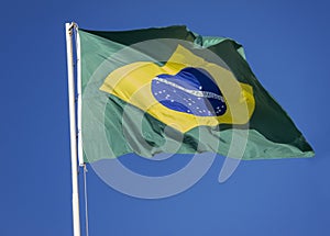 Brazilian Flag on a blue sky. photo