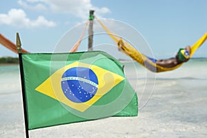 Brazilian Flag Waving in front of Beach Hammocks