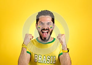 Brazilian supporter of National football team is celebrating, ch