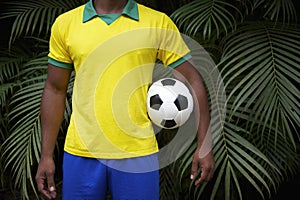 Brazilian Football Player Holding Soccer Ball in Jungle