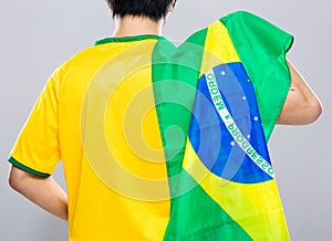 Brazilian football supporter hold with Brazil flag