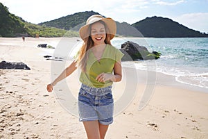 Brazilian girl dancing on empty beach. Carefree young healthy woman having fun on her summer holidays in Brazil