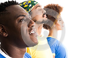 Brazilian group of fans celebrating on football match on white b photo
