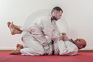 Brazilian jiu-jitsu training demonstration in traditional kimono