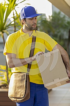 Brazilian mailman delivering a package