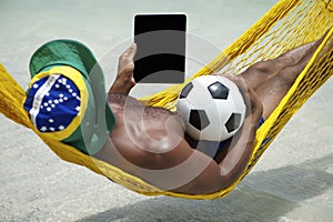 Brazilian Man Relaxing with Tablet and Football Beach Hammock