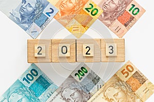 Brazilian money and the date 2023 on wooden blocks, Economic concept, Development of the Brazilian economy in 2023