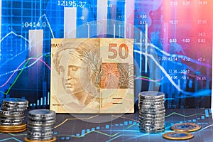 BRAZILIAN MONEY ON GRAPHIC, SYMBOL OF THE FINANCIAL MARKET photo