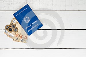 Brazilian money notes, Brazilian coins and work permit on white