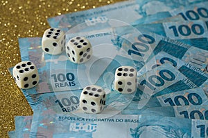 Brazilian money, reais and dice for the game / business concept