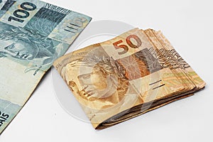 Brazilian money scattered photographed on a white background photo