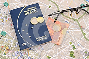 Brazilian passport, euros, glasses and map for travel abroad.