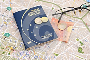 Brazilian passport, euros, glasses and map for travel abroad.