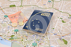 Brazilian passport, euros and map for travel abroad.