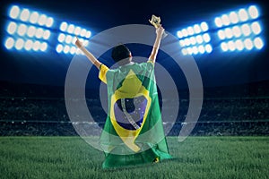 Brazilian player with flag and cup