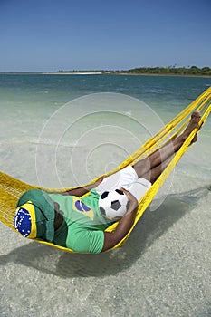 Brazilian Relaxing with Soccer Football in Beach Hammock