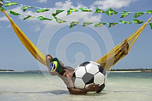 Brazilian Relaxing with Soccer Football in Beach Hammock