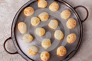 Brazilian snack cheese bread (pao de queijo) on oven-tray