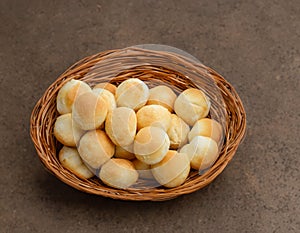 Brazilian snack cheese bread (pao de queijo) in wicker basket