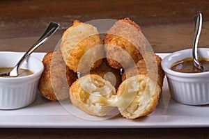 Brazilian snack with melted cheese. Fried cheese croquette with Brazilian appetizer. In Brazil called Bolinha de queijo