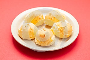 Brazilian snack pao de queijo cheese bread on white dish