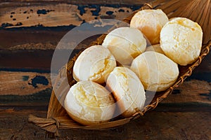 Brazilian snack pao de queijo (cheese bread) in wicker basket