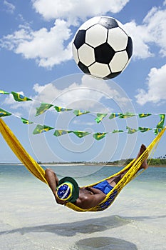 Brazilian Soccer Fan Relaxing in Beach Hammock