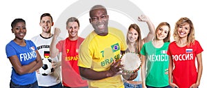 Brazilian soccer supporter with drum and fans from other countries